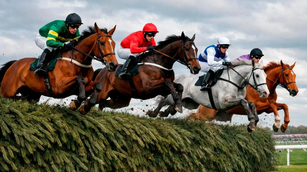 Pferde springen über den berühmten Becher-Zaun beim Grand National in Aintree